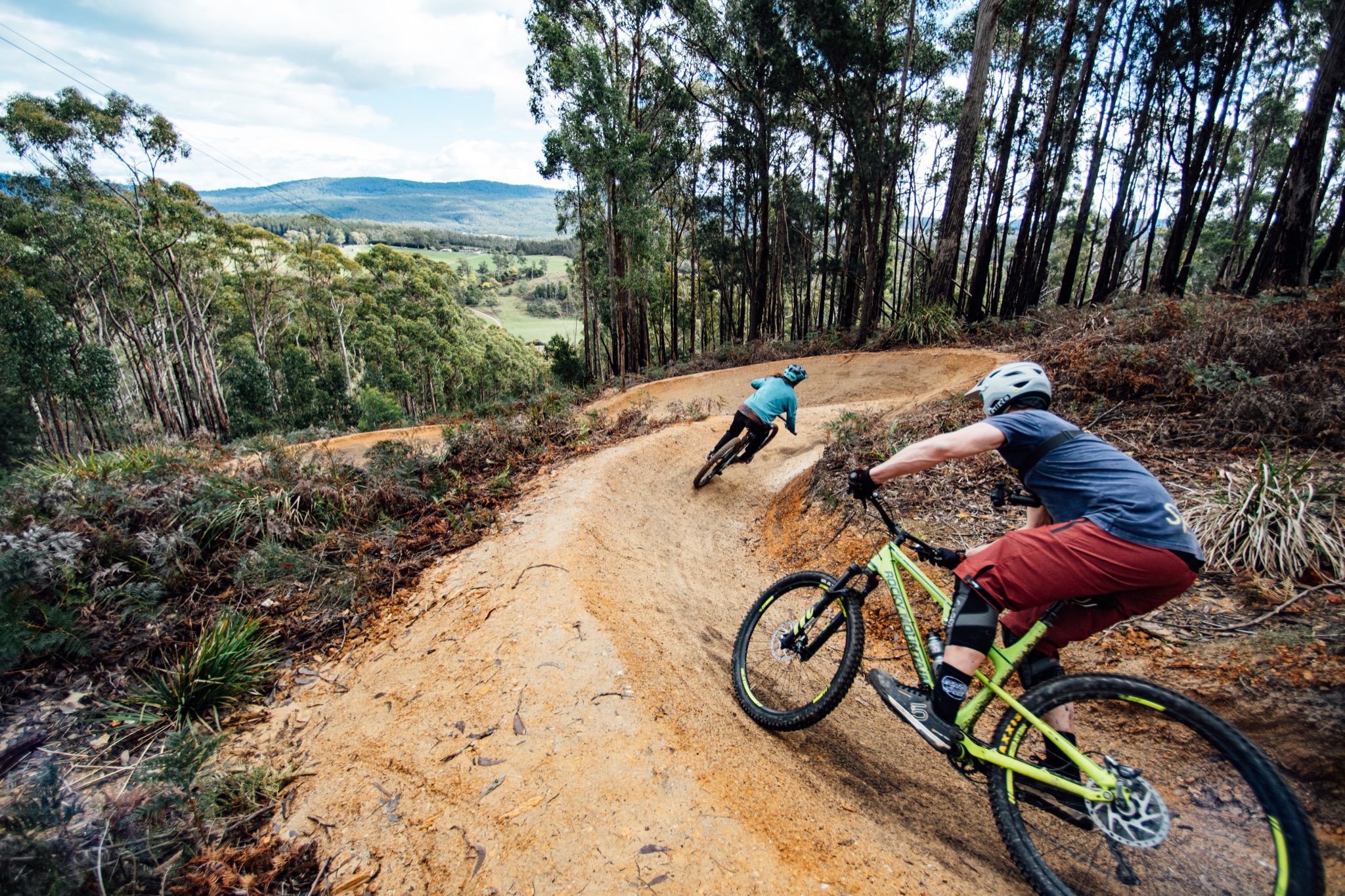 mountain biking in wild mersey, picture displays mountain bikers riding berm corners